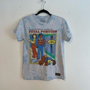 Steven Rhodes "Assume the Fetal Position" t-shirt with a light blue tie-dye wash